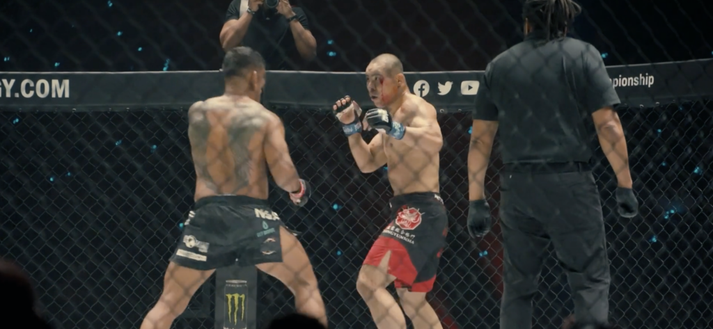 two MMA fighters square up inside a fight cage