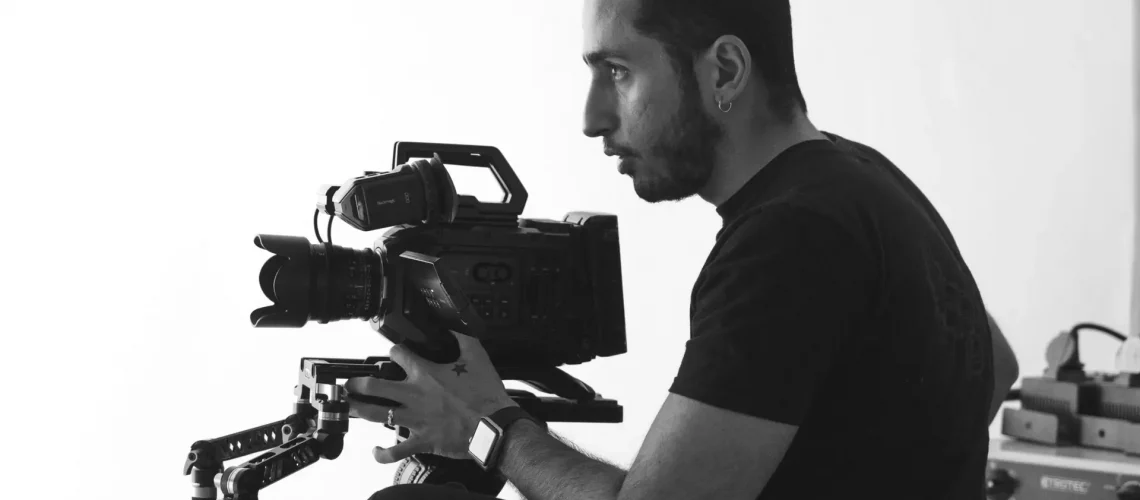 A videographer holding a camera to compile vide files