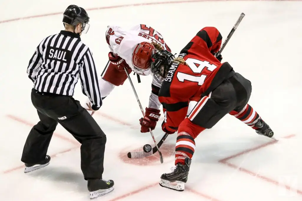 Players and referee in a hockey game to start the game