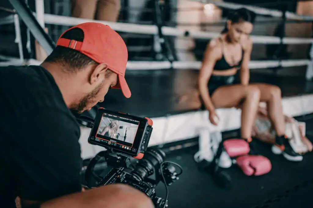A videographer capturing a fighter's routine