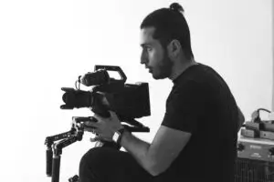 A videographer holding a camera to compile vide files