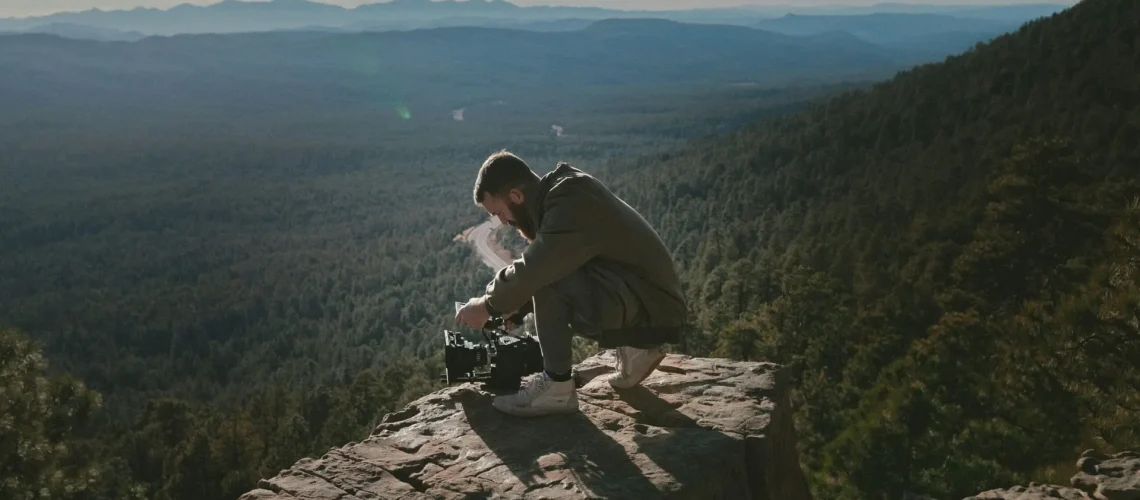 A man capturing nature on a mountain top