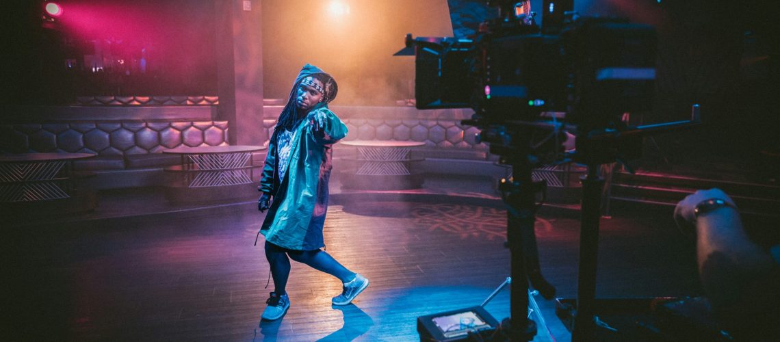 A music artist dancing as a part of her routine in a music video