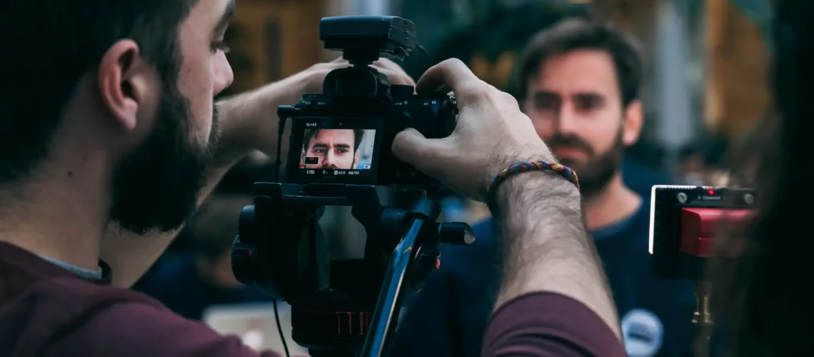 A videographer zooming on the face of a worker for corporate content