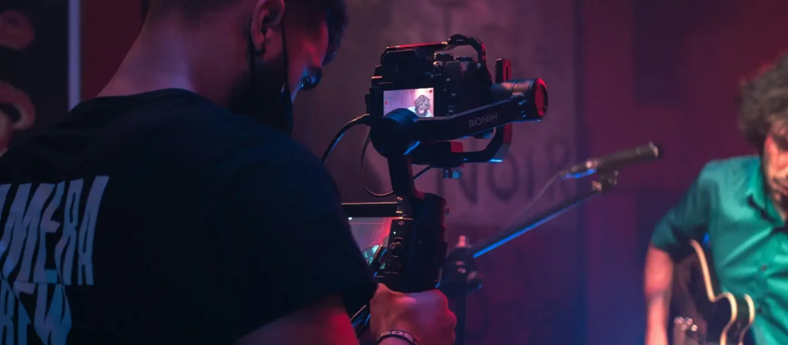 A videographer capturing a music video scene