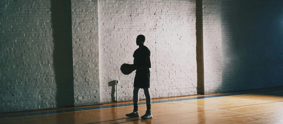 A basketball player in the dark