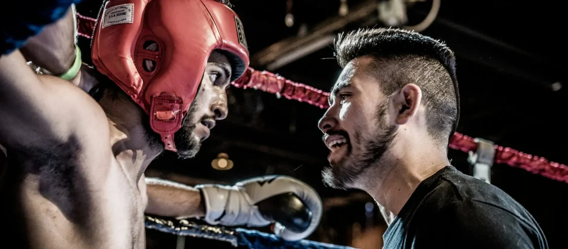 UFC fighter talking to his coach before the next round of the fight