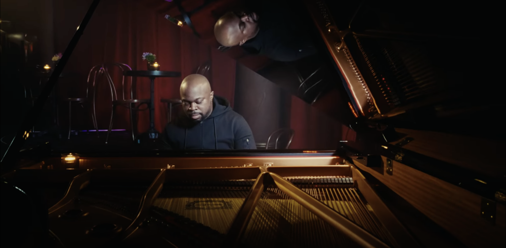 an African American piano player at the piano performing