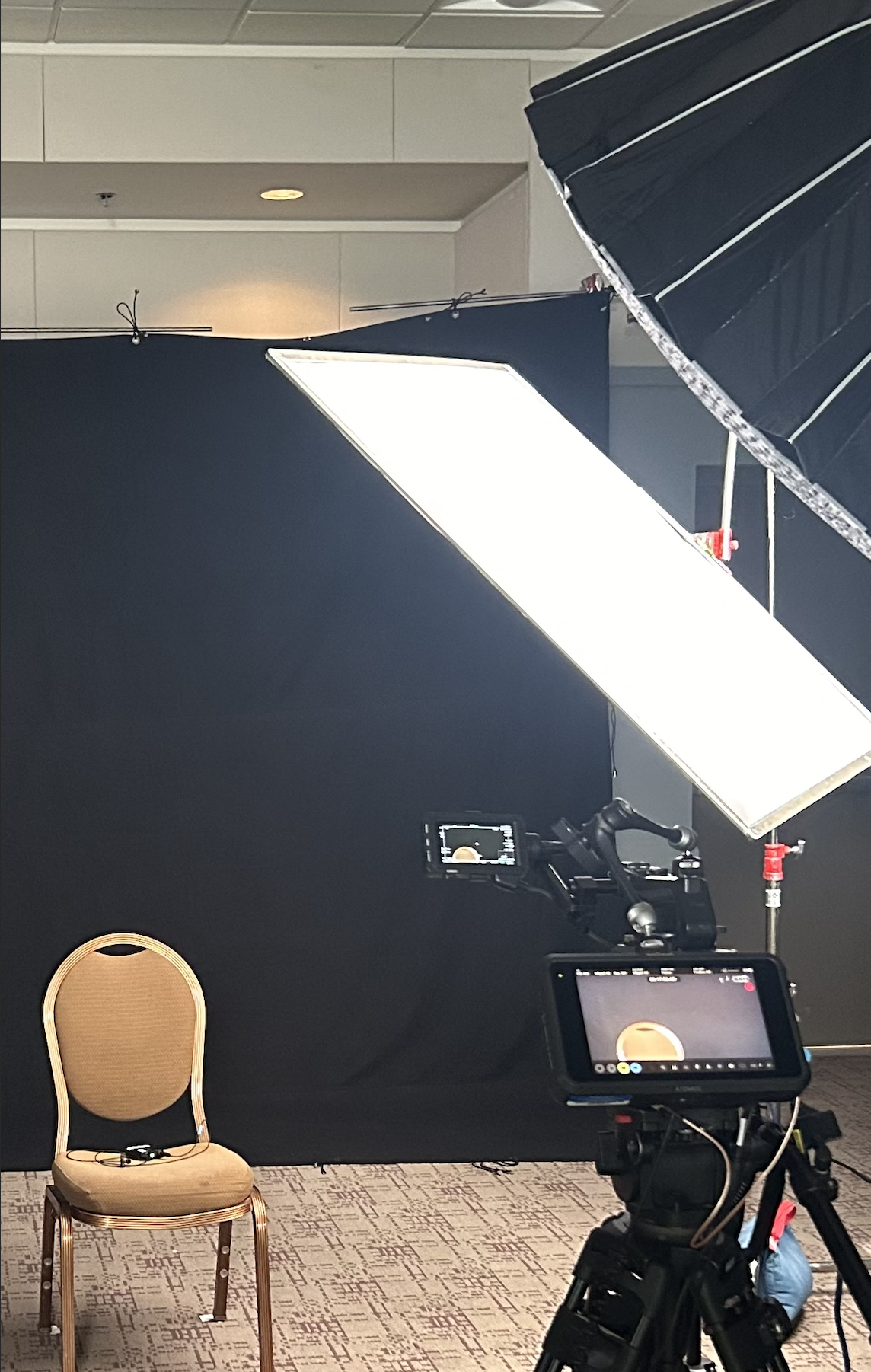 a chair is placed and is professionally lit for an interview setup