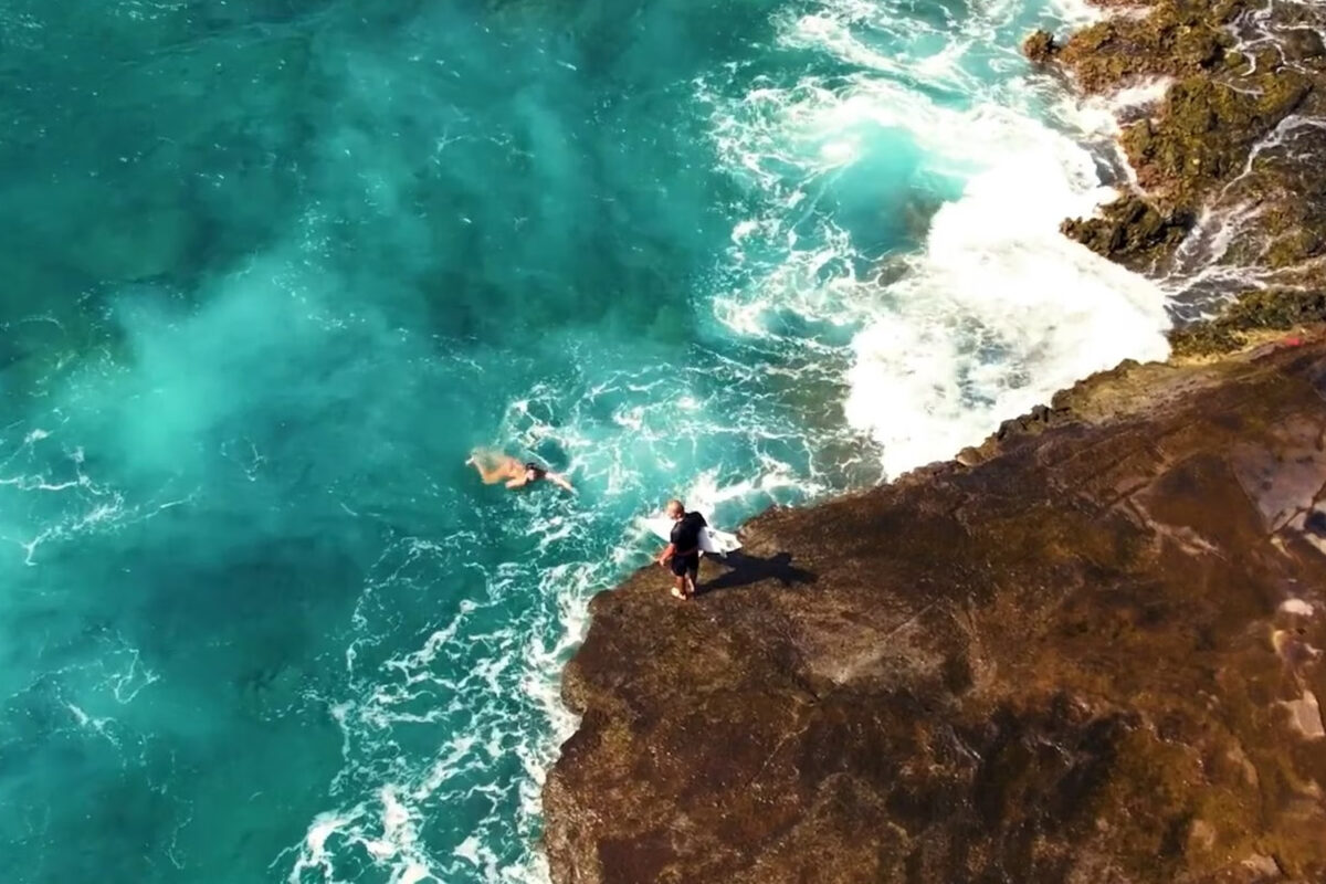 a woman is swimming ashore