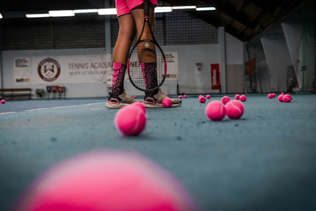 Scattered pink balls for tennis during a game