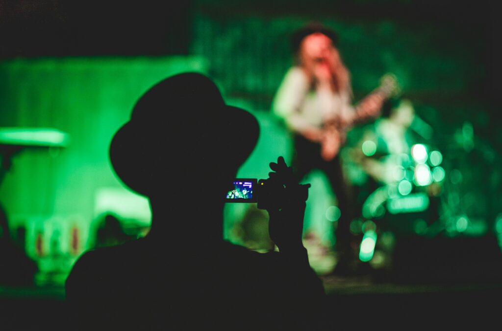 Man recording a live performance as a video service