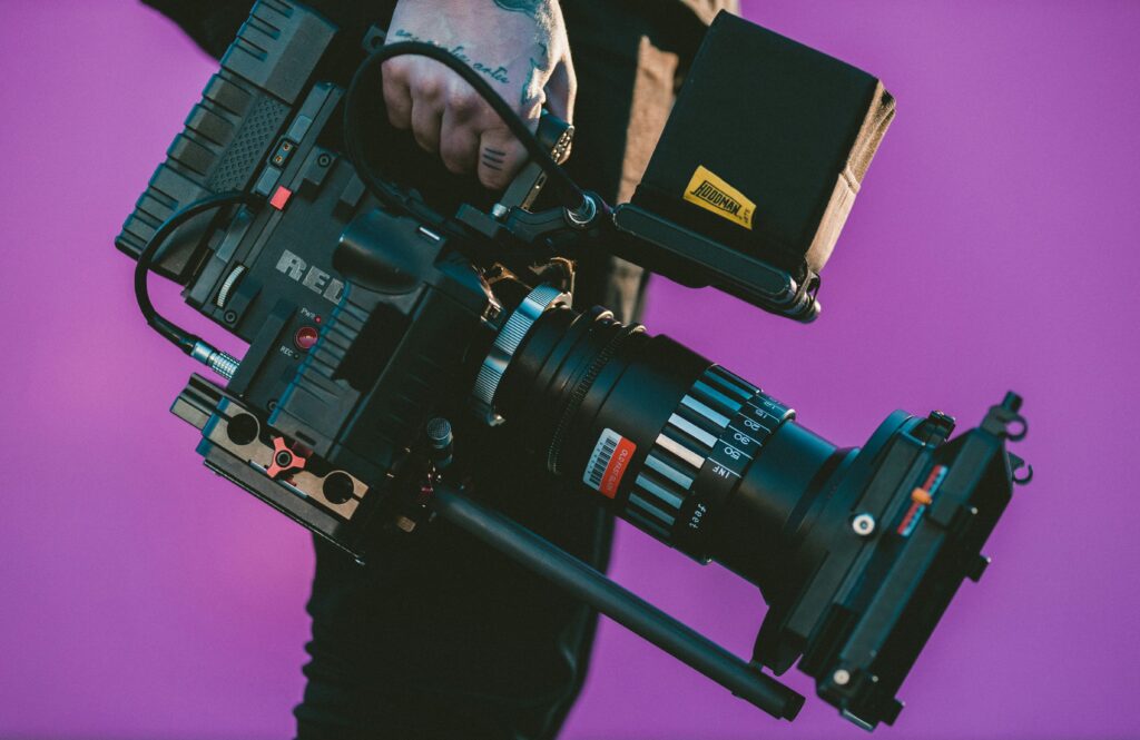 A HUSTL Media crew holding a high-technology camera for an interview production.