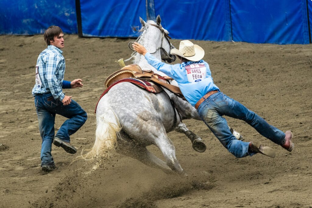 A cowboy falling from his horse during NFR