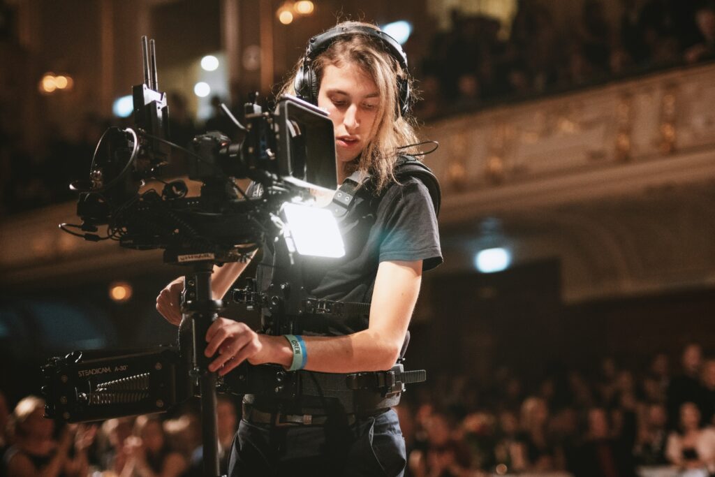 A videographer capturing the events in a red carpet event