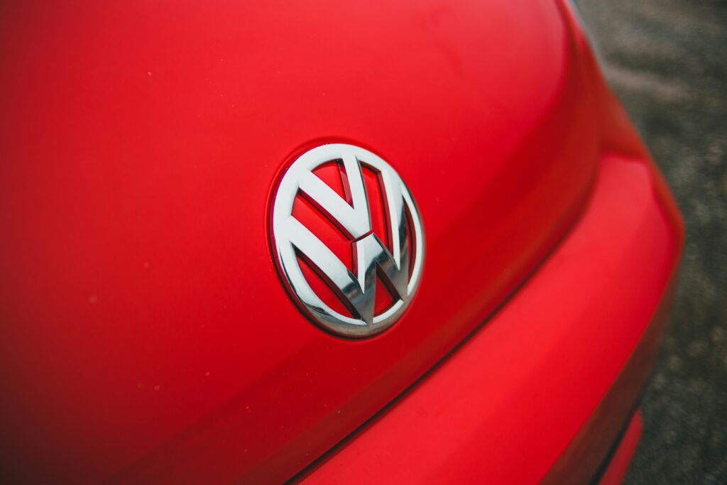 The logo of Volkswagen brand in a red car