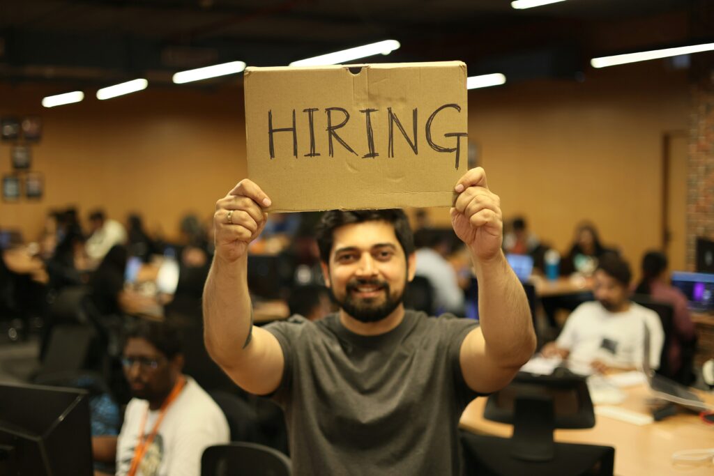 A man raising a hiring sign