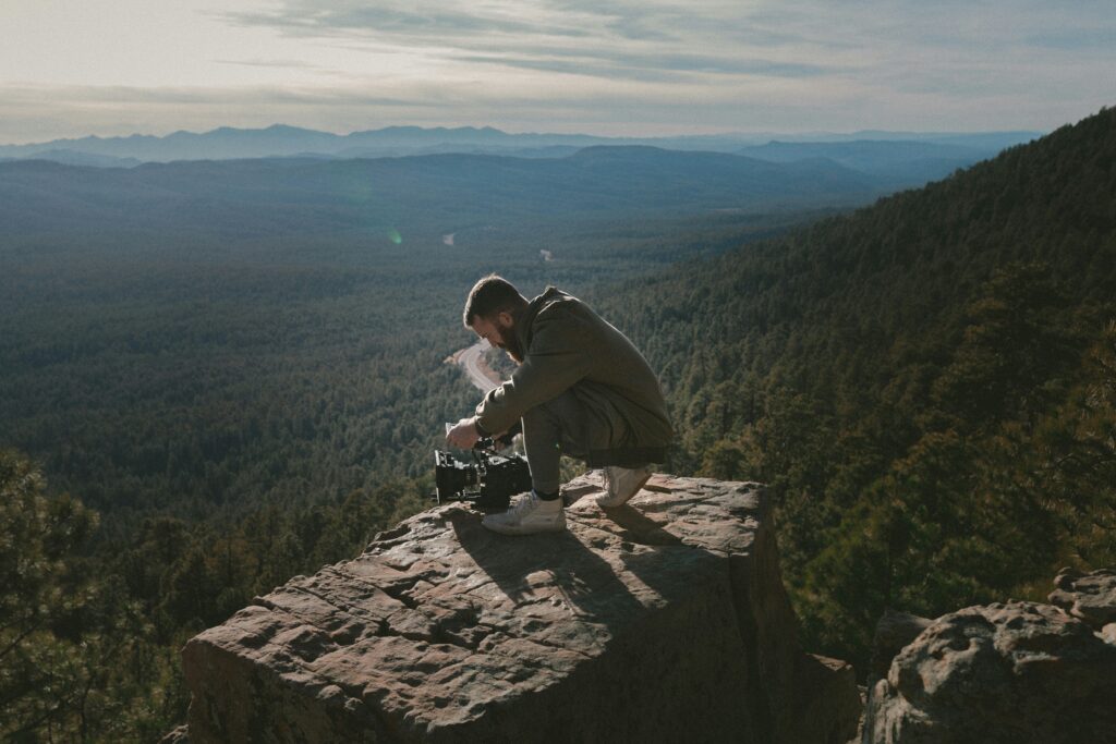 A man capturing nature on a mountain top