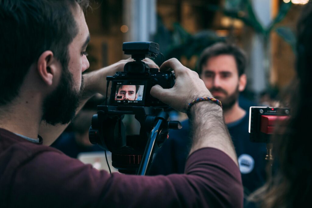 A videographer setting his camera for a corporate interview.