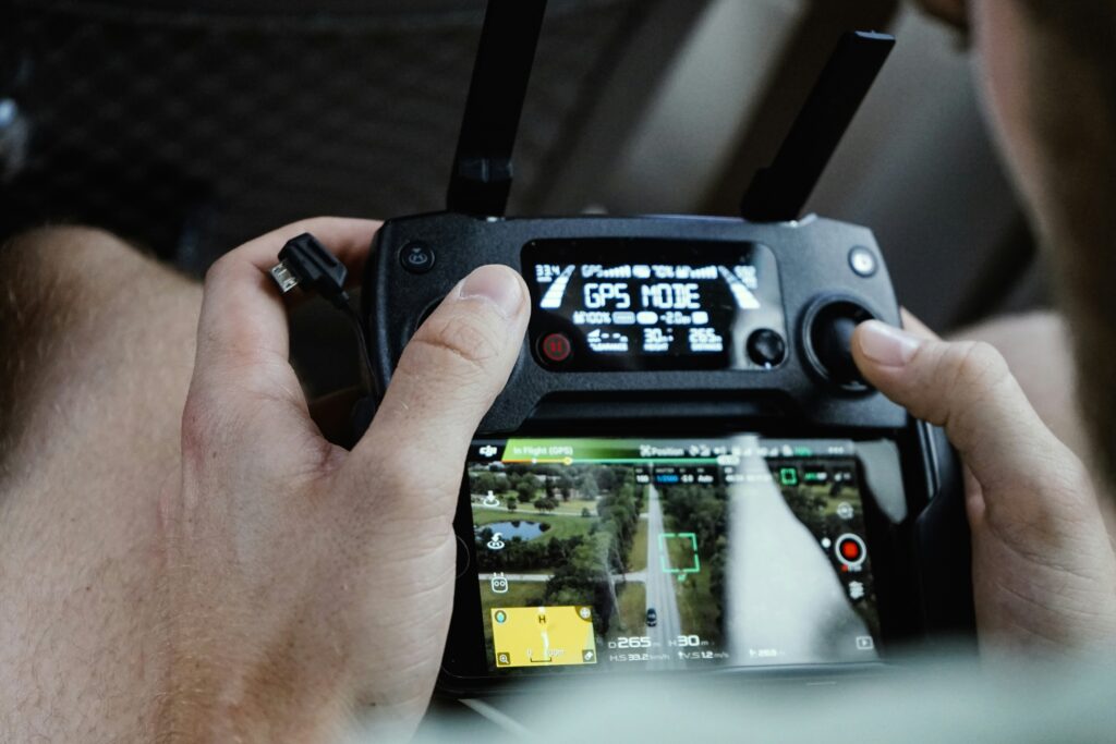 A gamer holding a modern game control device on a GPS mode