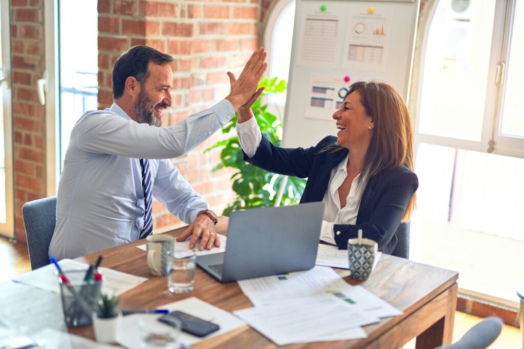 Business partners doing a high-five to celebrate