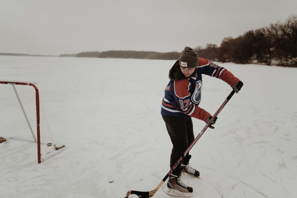 A boy playing hockey in snow