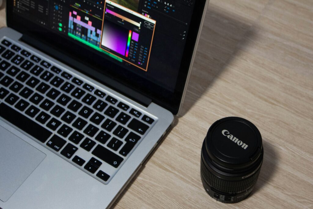 A laptop and camera lens case on a table