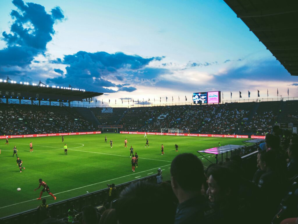 A soccer stadium full of fans and audience watching