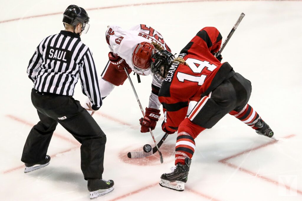 Players and referee in a hockey game to start the game