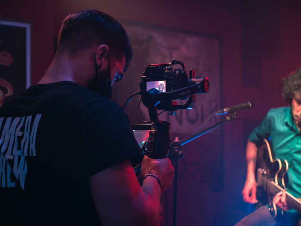 A videographer capturing a music video scene