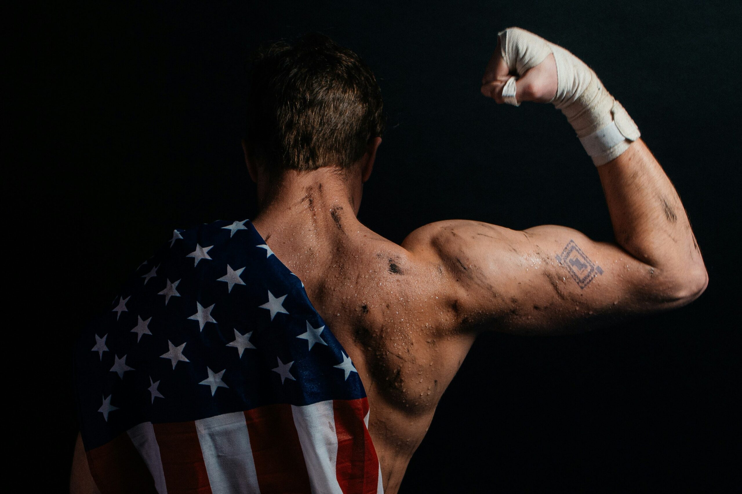 American Cornhole League player flexing before the game