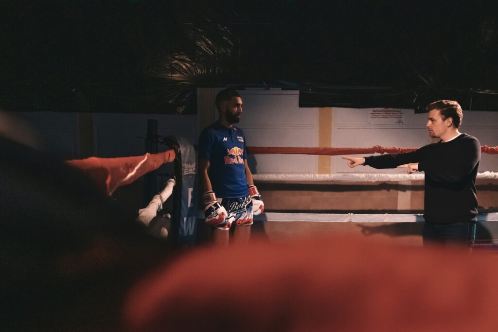 A boxer getting instructions from the director