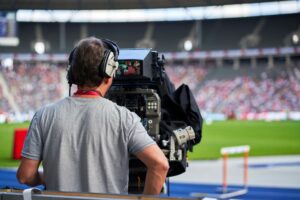 A videographer capturing the live actions in a soccer game