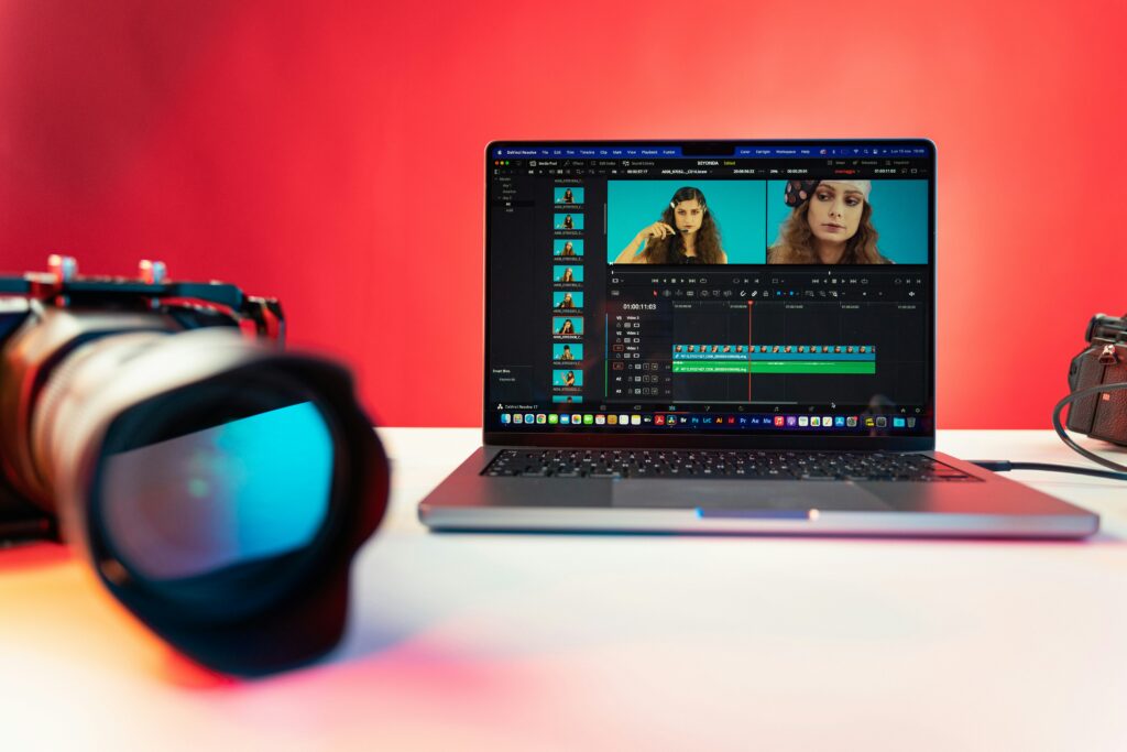 A laptop and a camera on a table as basic equipment for video production and editing