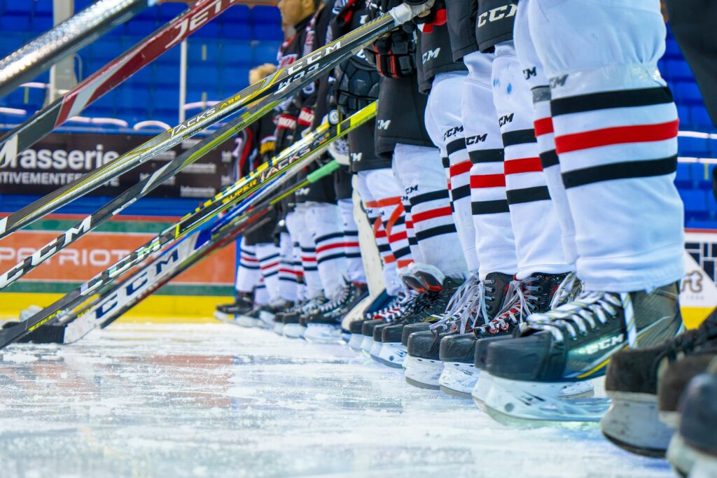 Hockey players lined up with their equipment