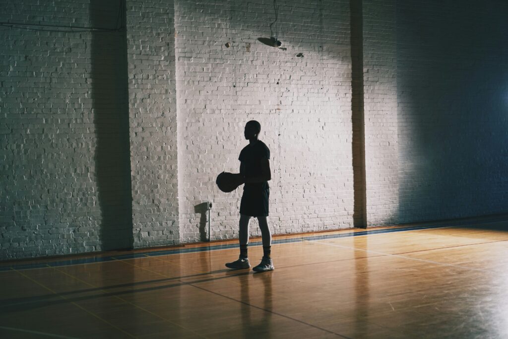 A basketball player in the dark