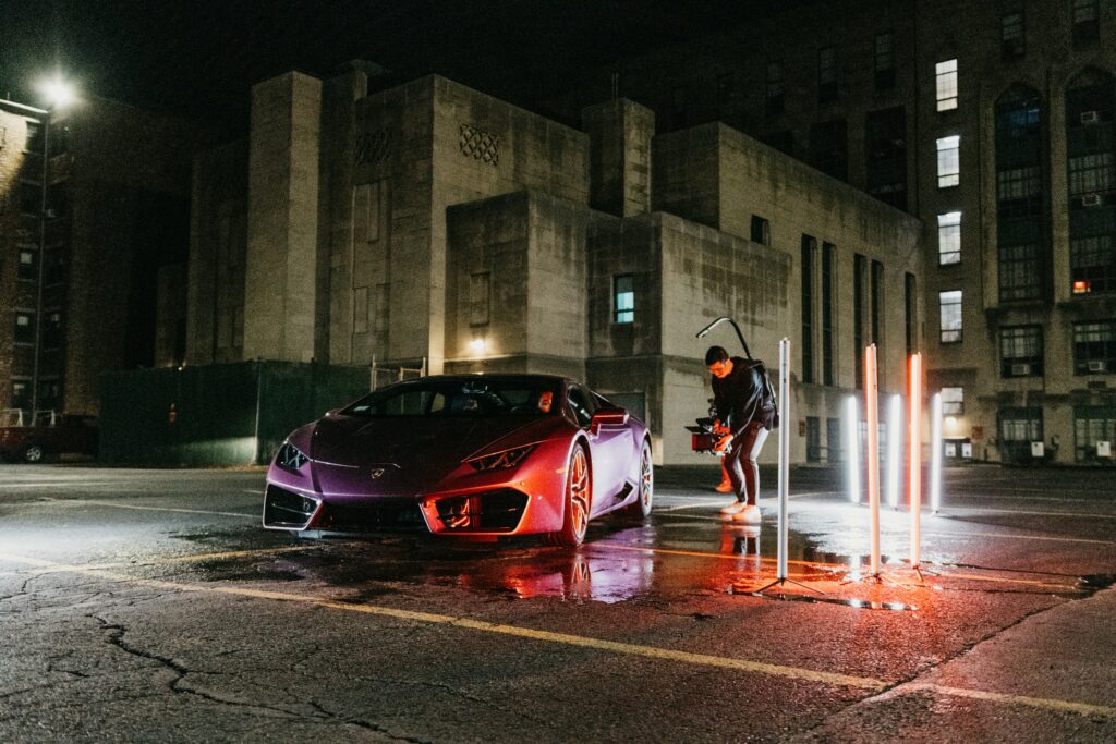 A camera crew operator shooting a car promotion